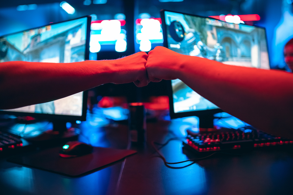 esports game fist bump over computer monitors